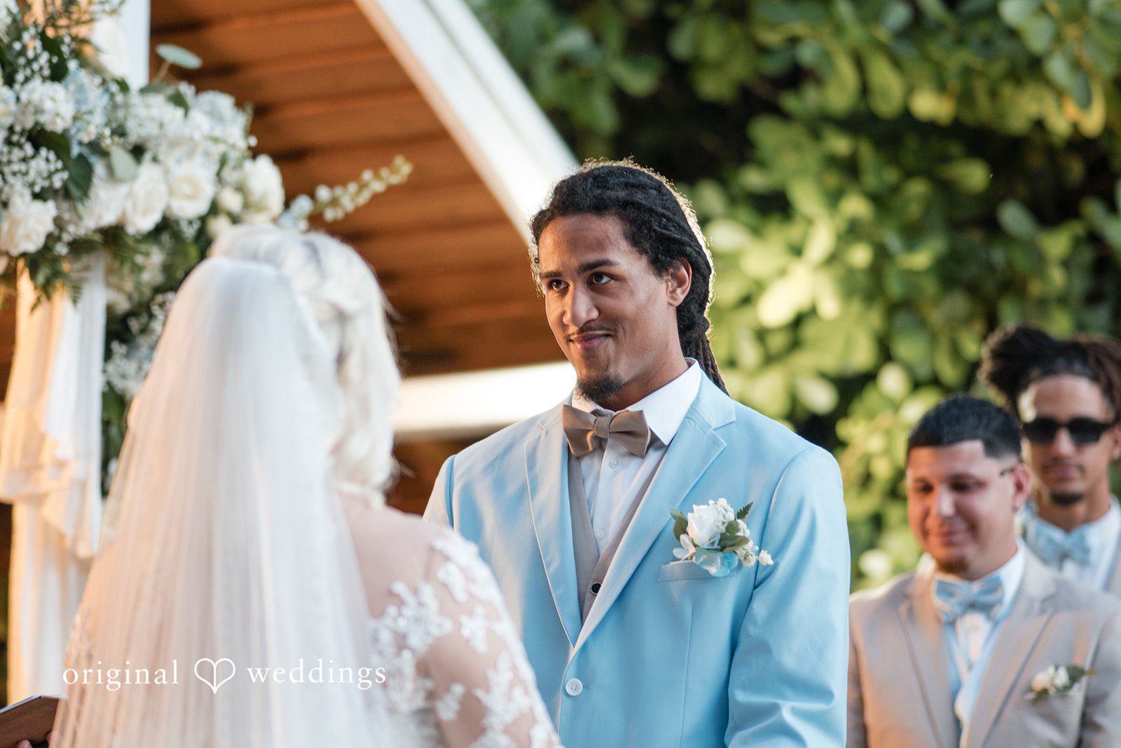 Romantic wedding photo of groom smiling at Lovely Barn