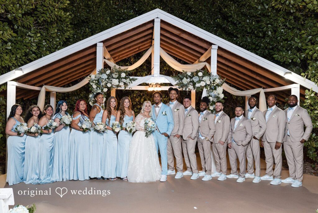 Miami Wedding Photographer capturing group photo of couple with bridesmaids and groomsmen at Lovely Barn by Original Weddings