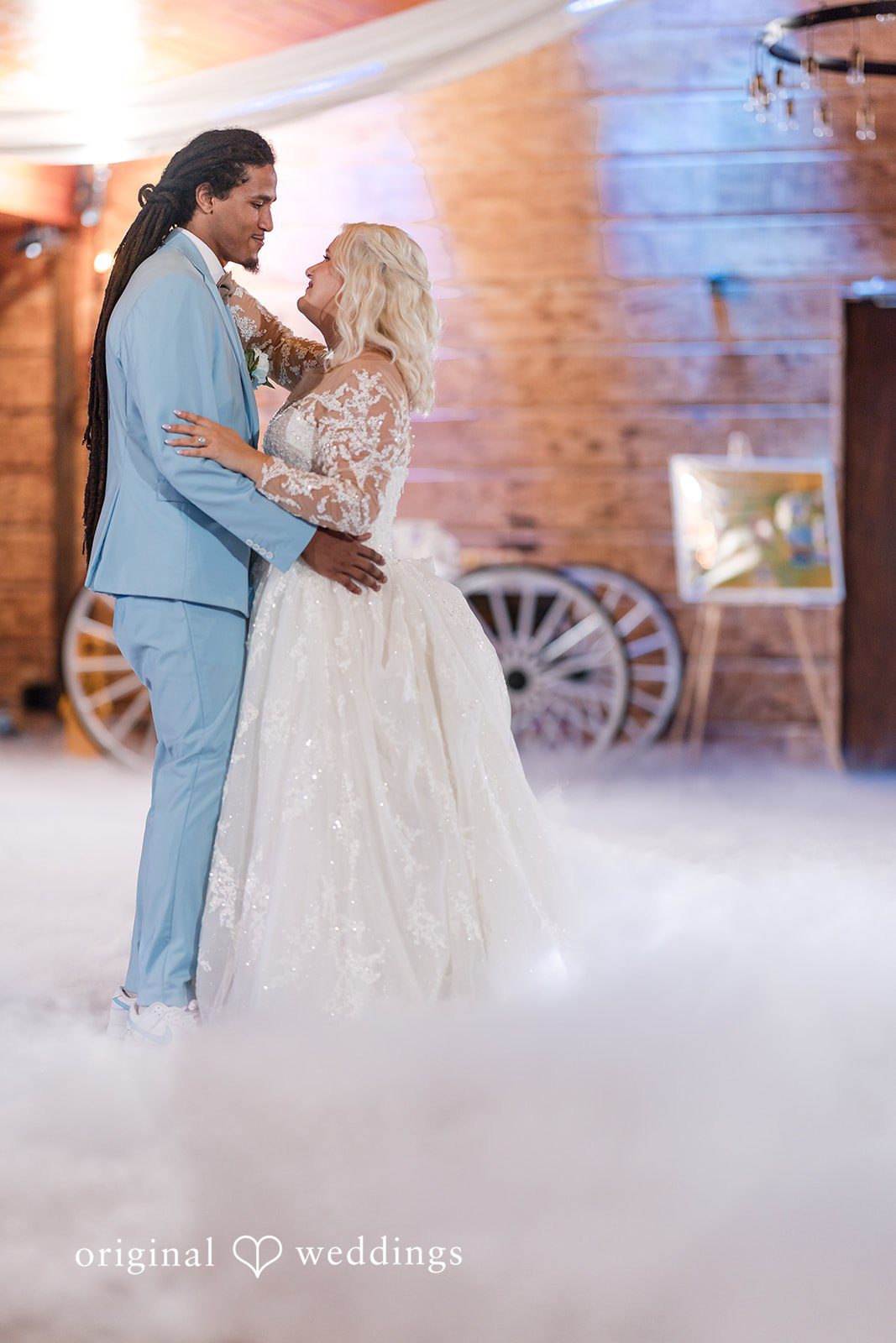 Loving couple sharing a romantic dance while looking at each other at Lovely Barn