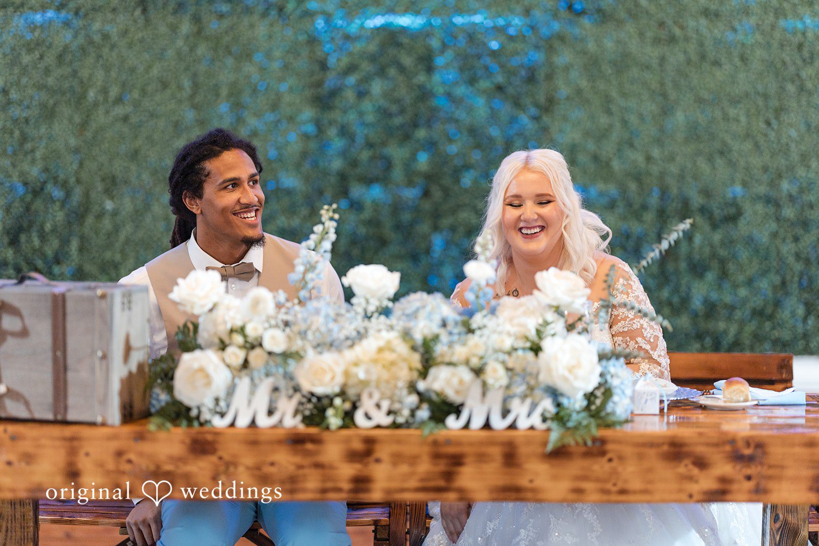 Bride and groom sitting together at a beautifully decorated table