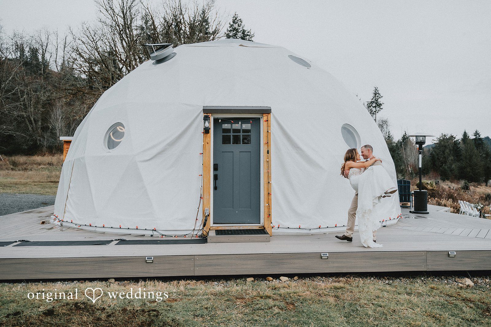 Kelsey + Adam Couple outside a white glamping tent.
