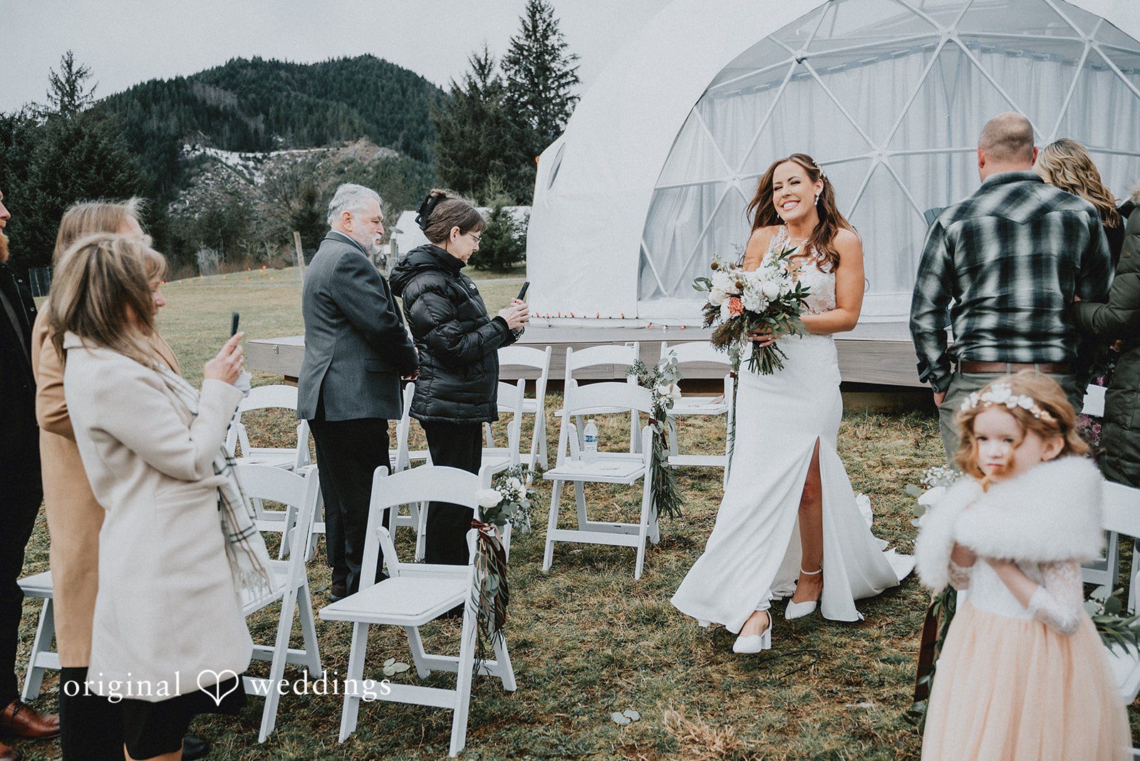 Kelsey + Adam Bride walking down the aisle with guests around.