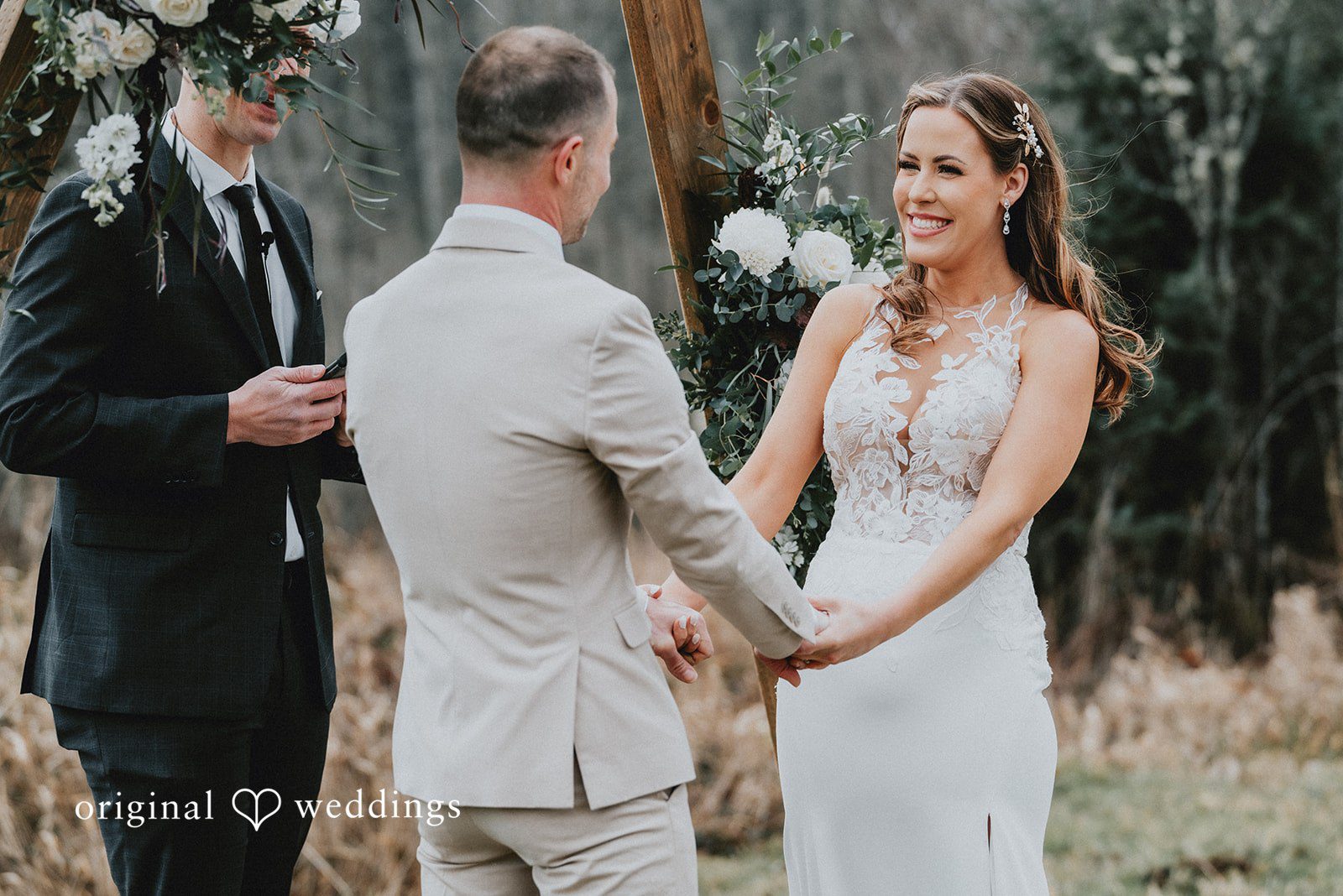 Kelsey + Adam Bride and groom holding hands during ceremony.