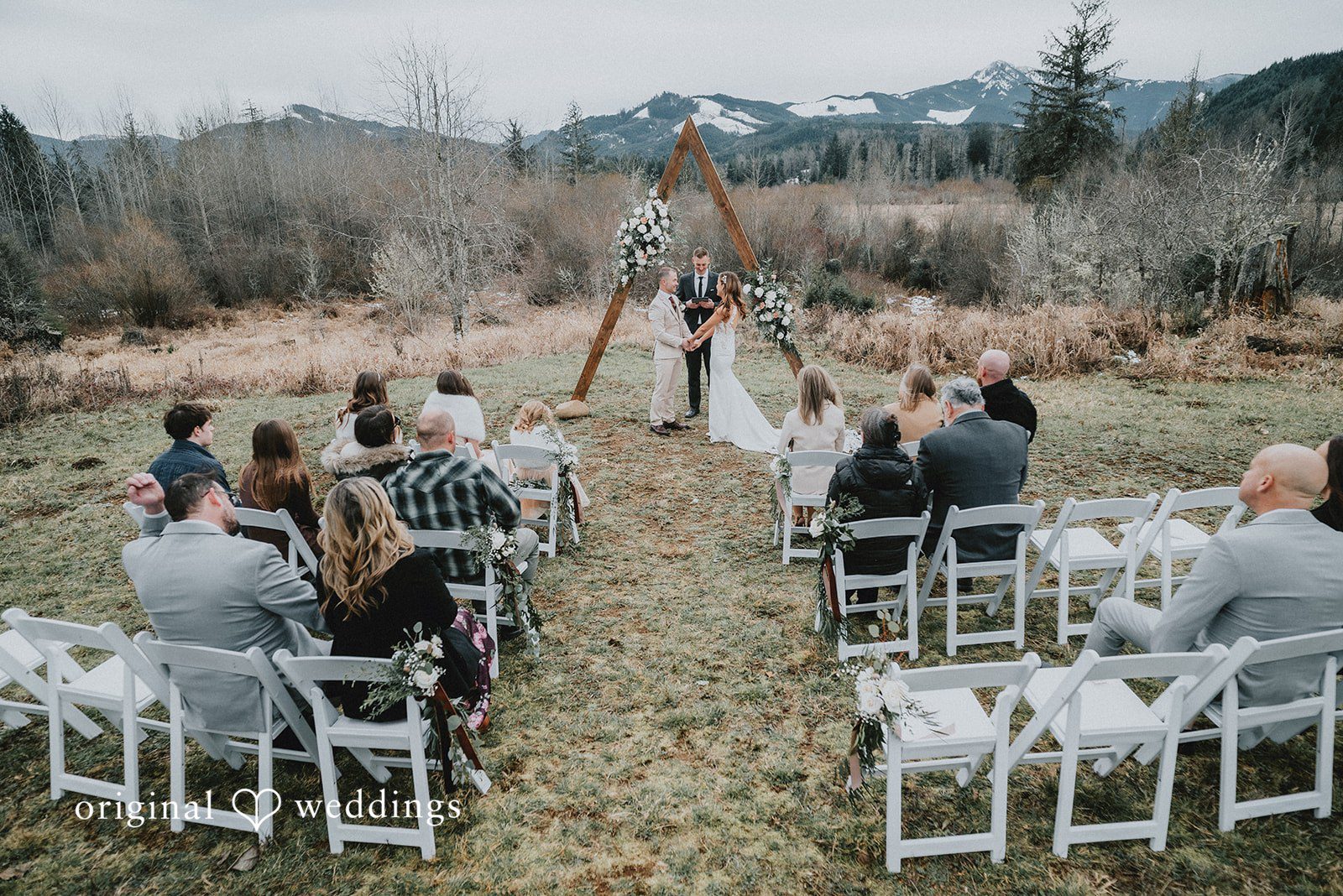 Kelsey + Adam Guests seated outdoors facing the wedding arch.
