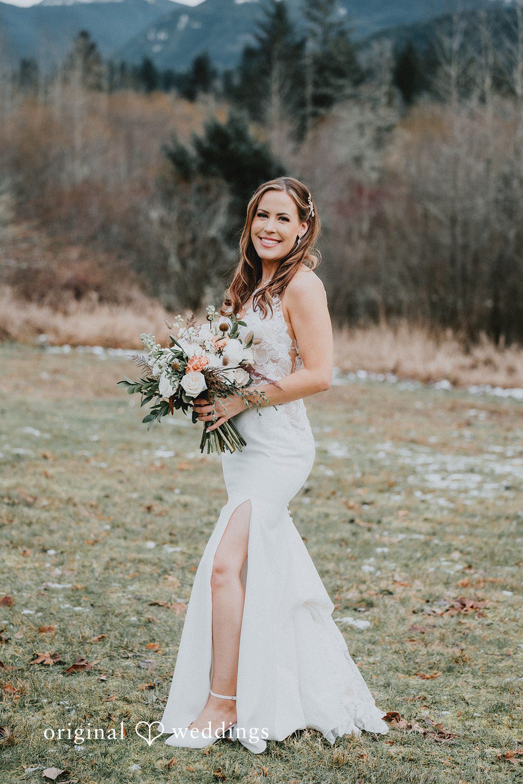 Kelsey + Adam Bride standing outside holding bouquet in a white dress.