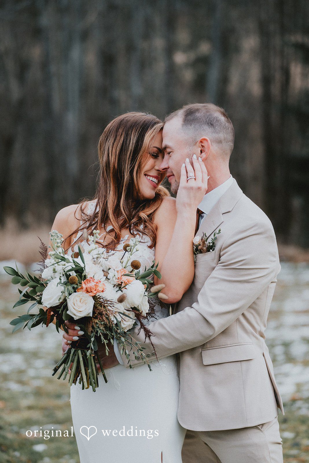 Kelsey + Adam Couple hugging with bouquet.