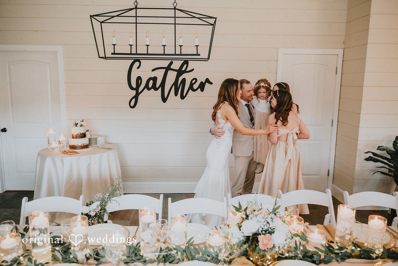 Kelsey + Adam Family posing by wedding decor.