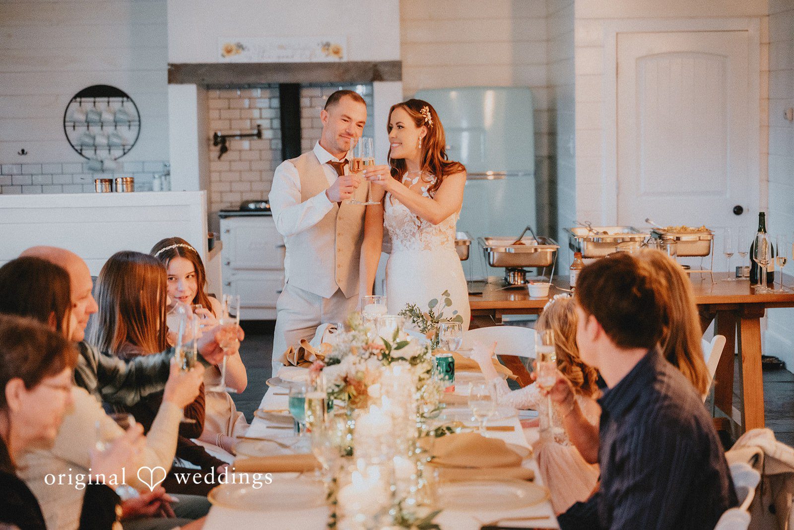 Kelsey + Adam Bride and groom toasting at a wedding reception.