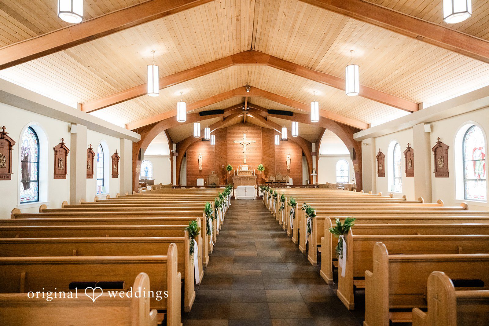 Celine + Cassin Interior of a church decorated for a wedding ceremony.