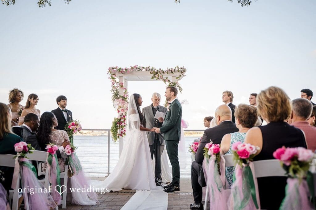 The bride and groom walk forward to applause, captured beautifully by Tampa Wedding Photography.