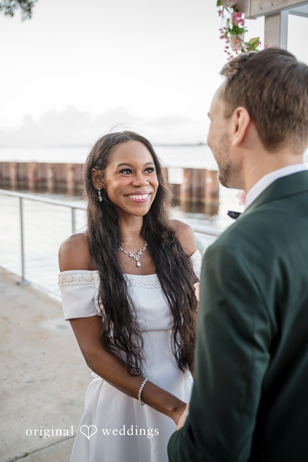 The bride and groom smile during a romantic conversation.