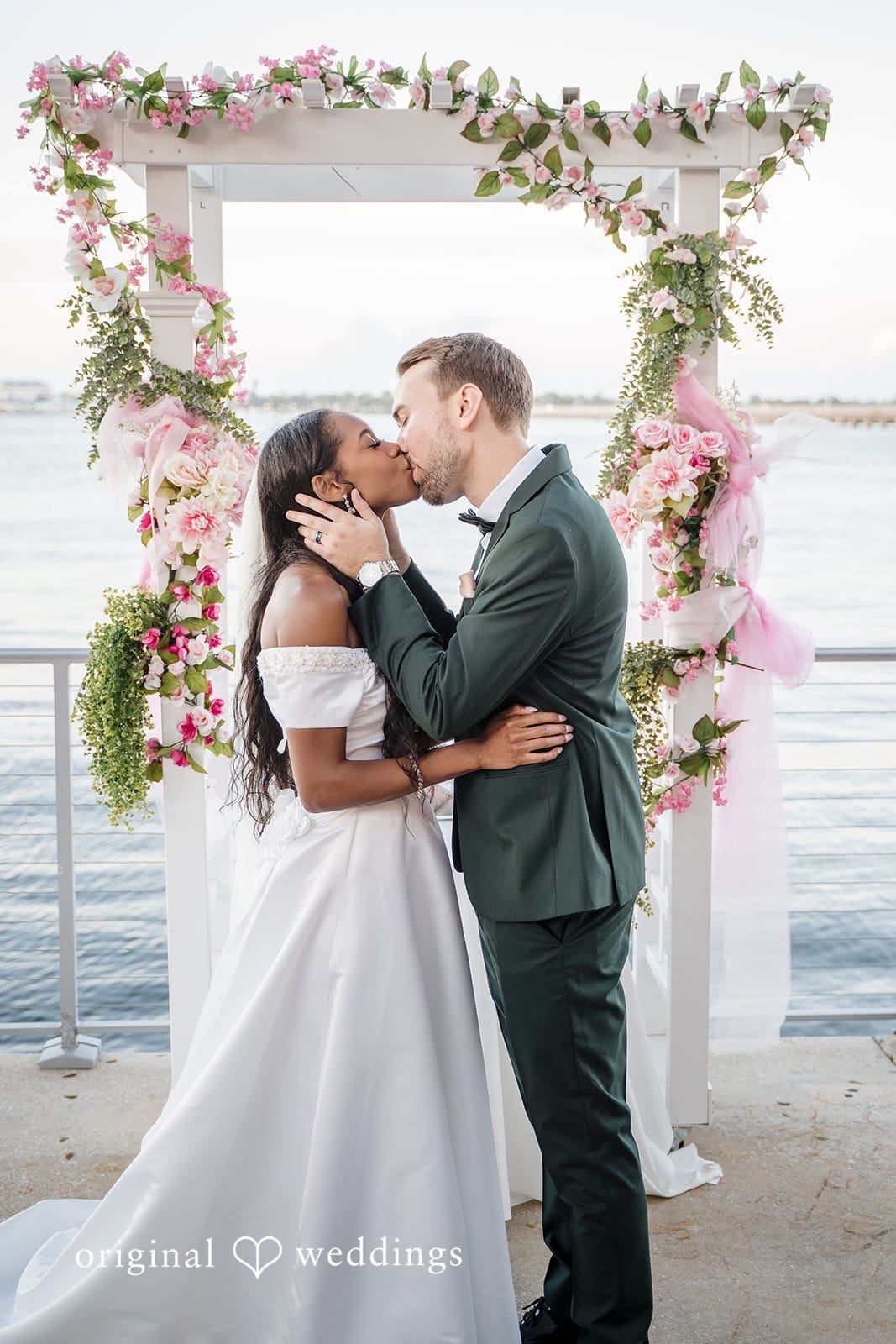 The bride and groom seal the moment with a romantic kiss.