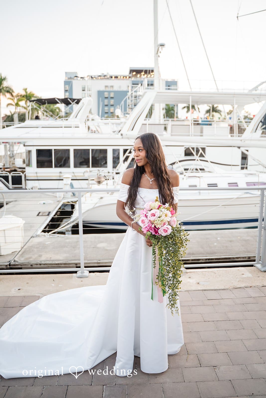 The bride captures a natural and elegant moment by the sea.