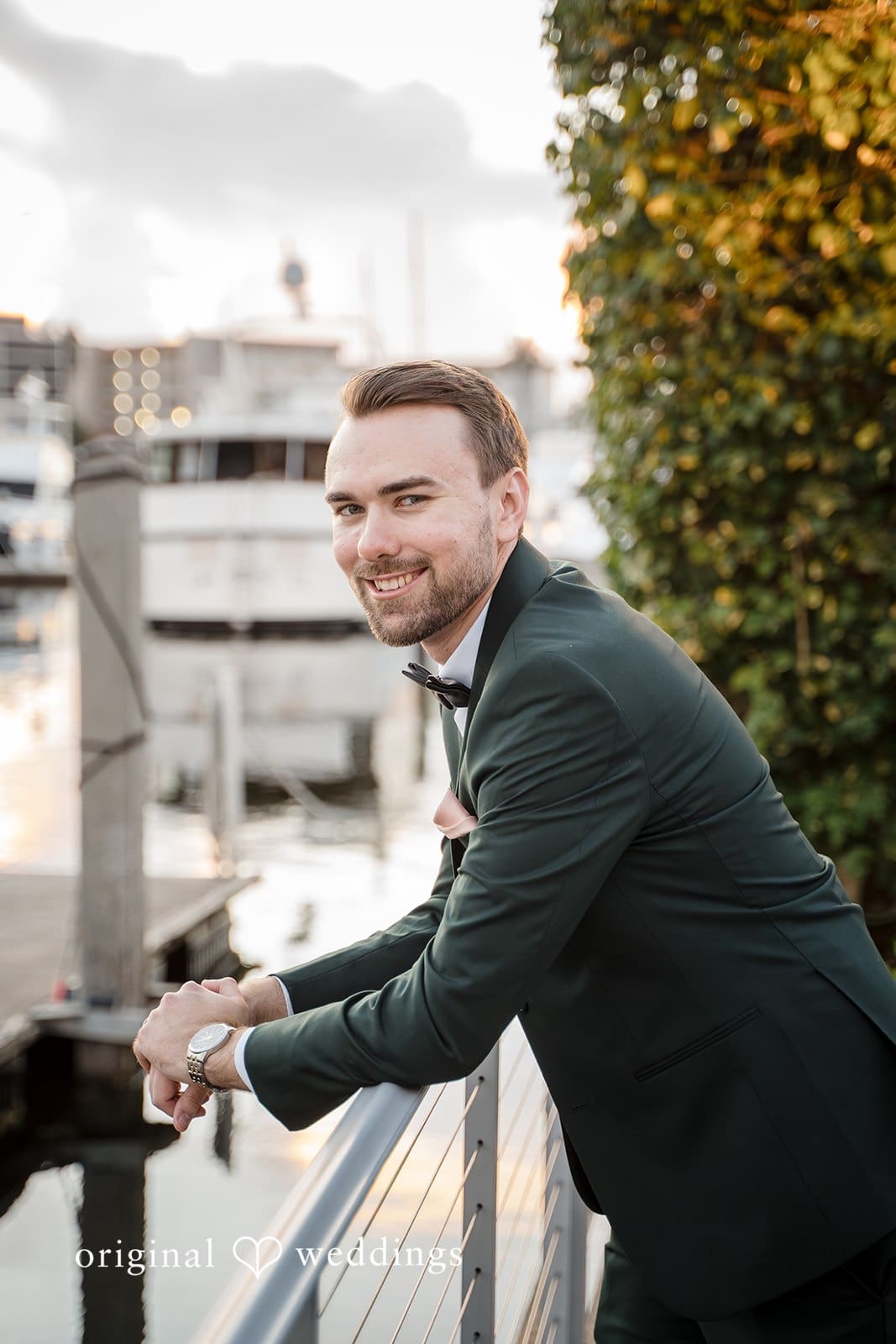 The groom enjoys the day while posing casually.