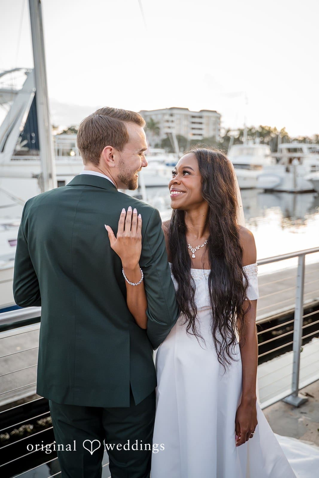 The bride and groom embrace each other warmly.