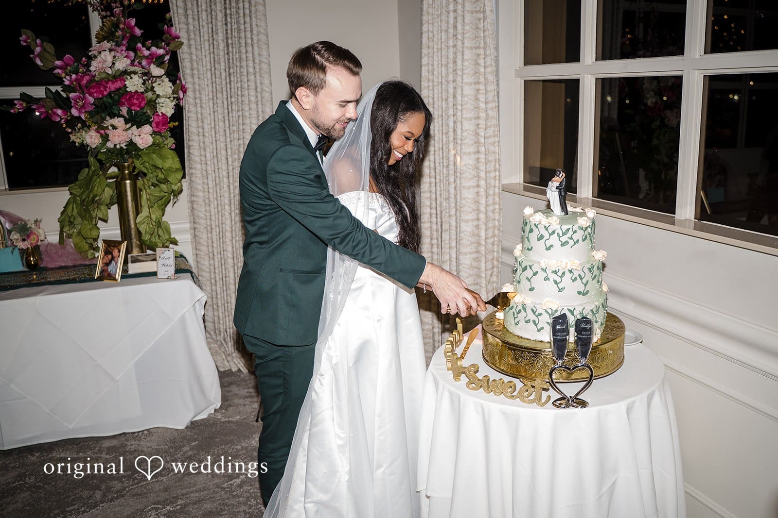 Their happiness is evident as they cut the wedding cake.