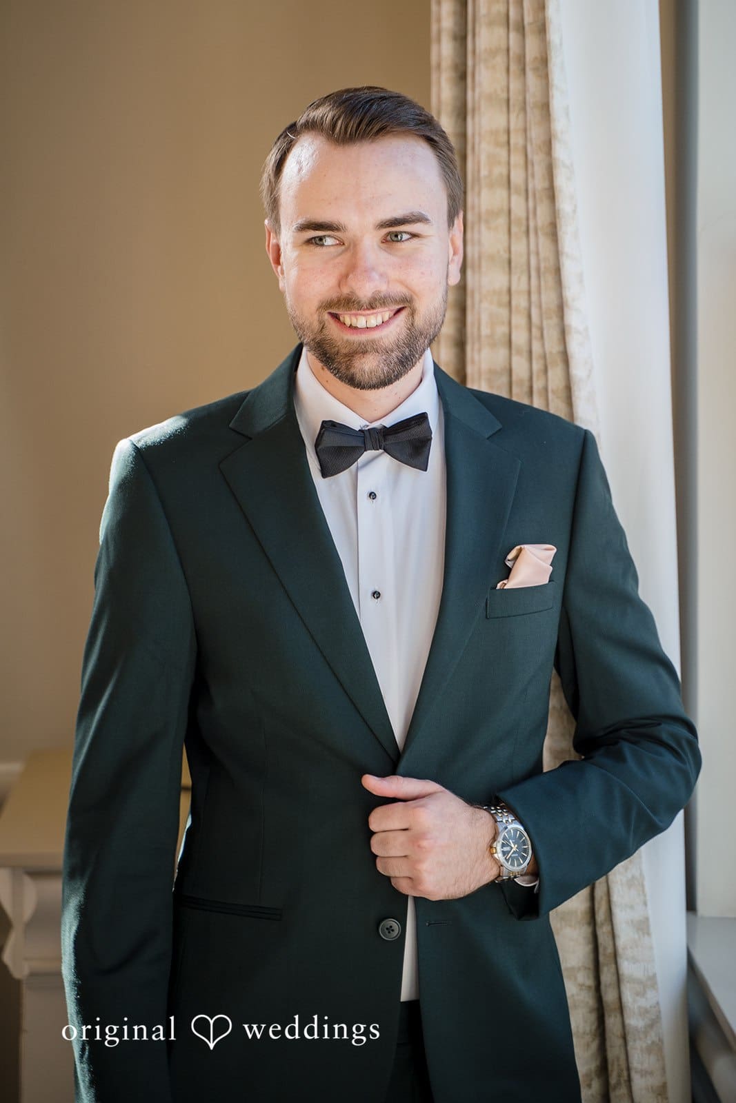 The groom poses confidently in his elegant attire.