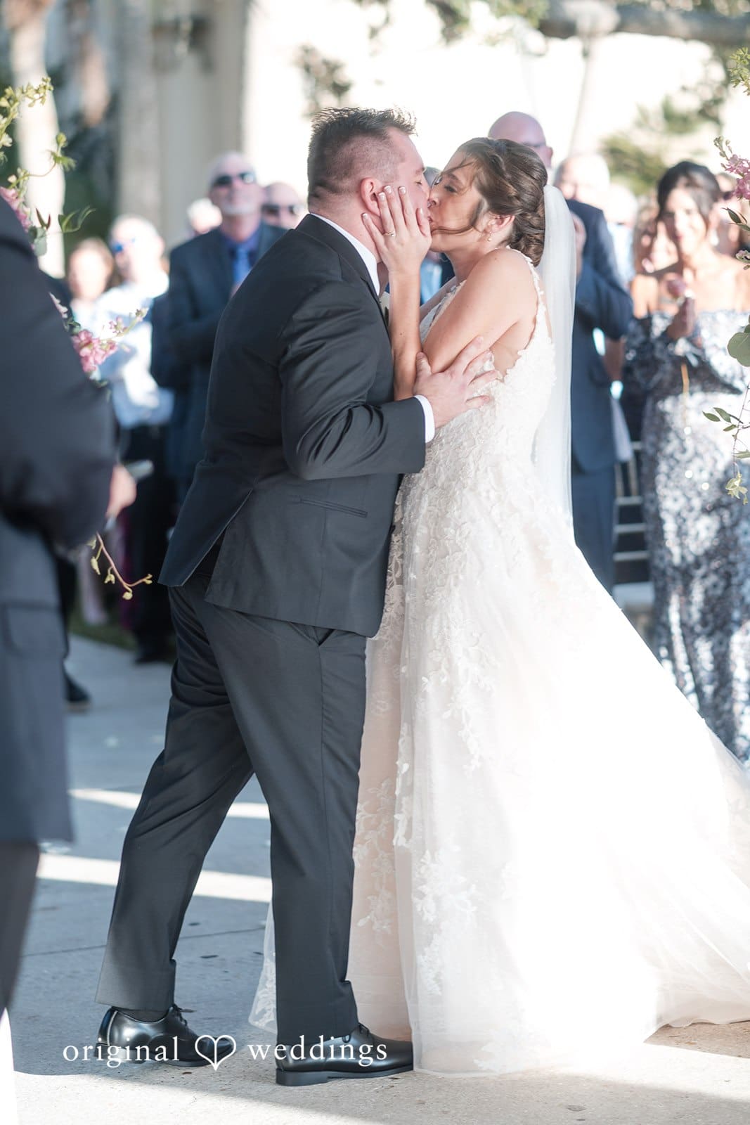 Nicole + Hunter Romantic moment of bride and groom kissing after wedding ceremony
