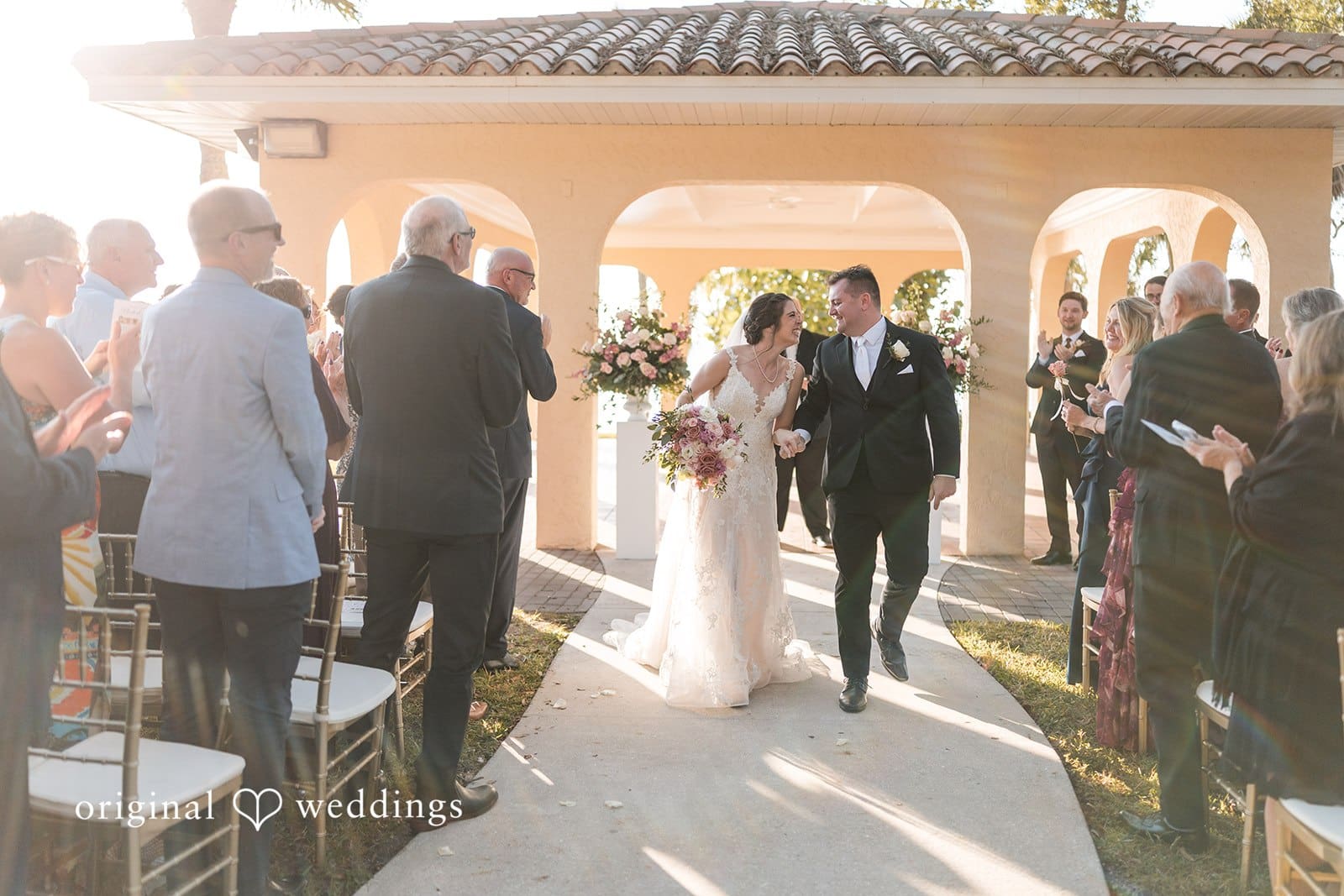Nicole + Hunter Newly married couple walking hand in hand after ceremony celebration