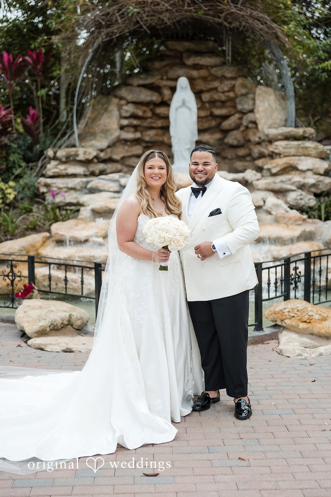 A portrait of the couple in front of the chapel