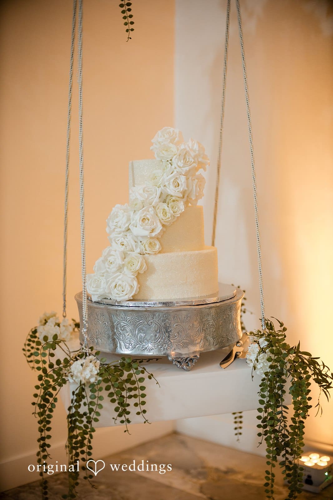 A beautiful cream-colored cake at the Prestige Estate wedding reception