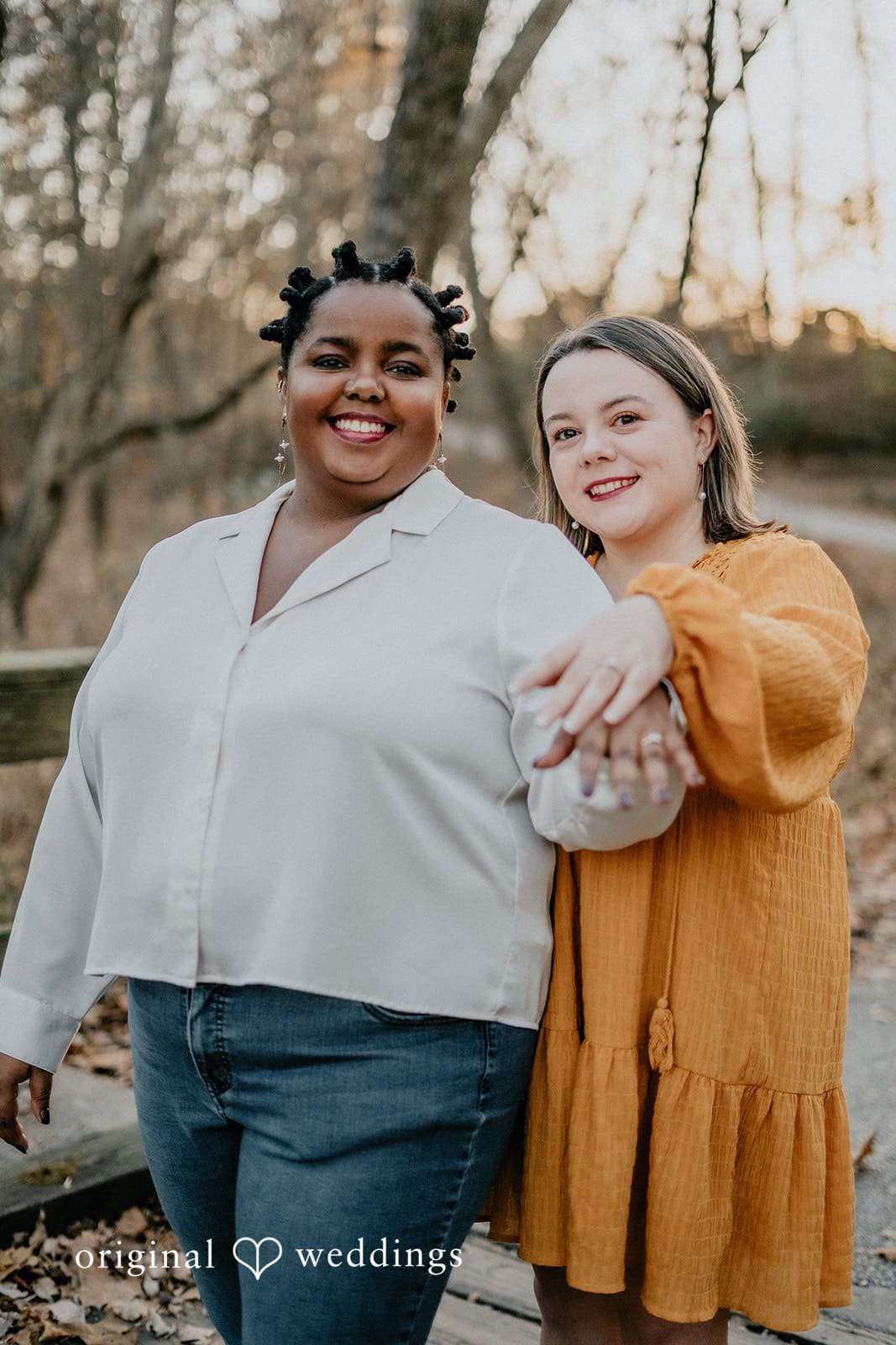A happy portrait of the couple showing off their engagement rings at Queeny Park