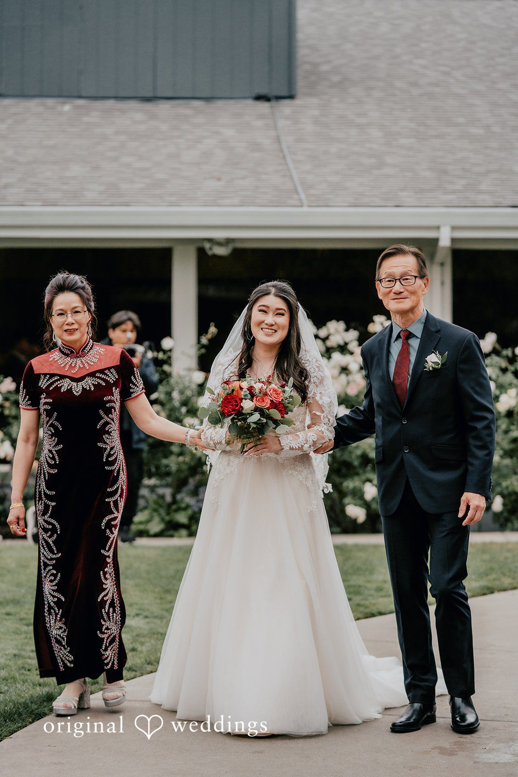 A heartfelt portrait of the bride's parents walking her down the aisle