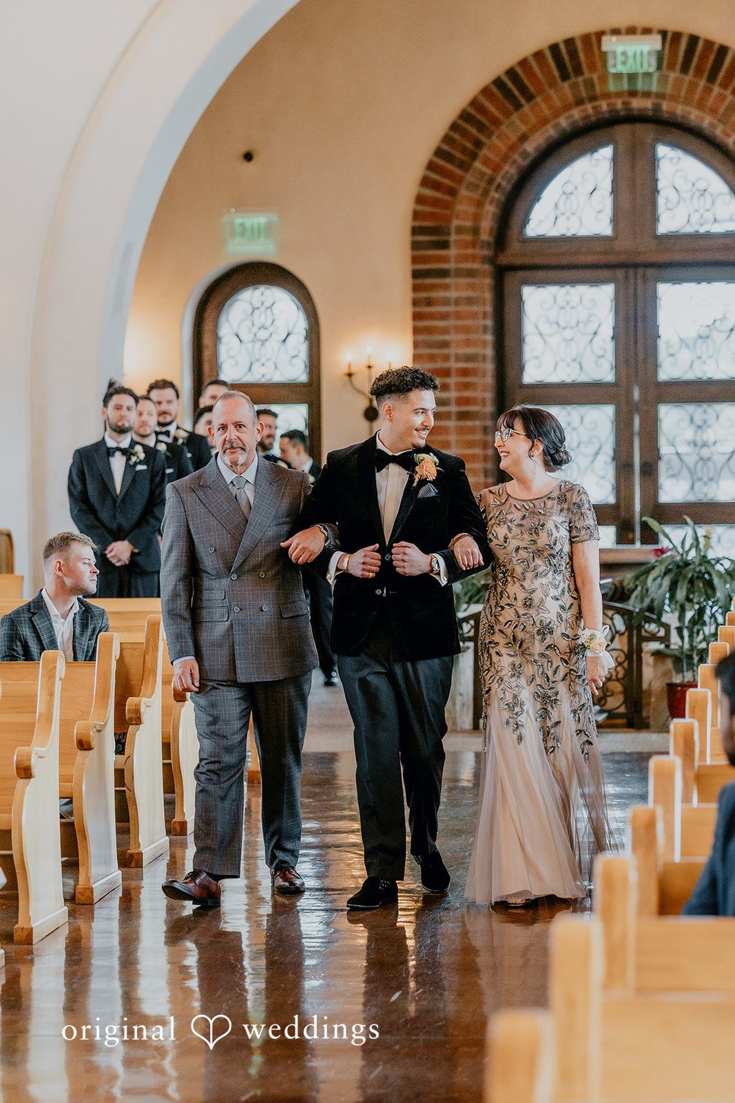 Jakob + Flowreen A happy moment the groom's parents escorted him down the aisle