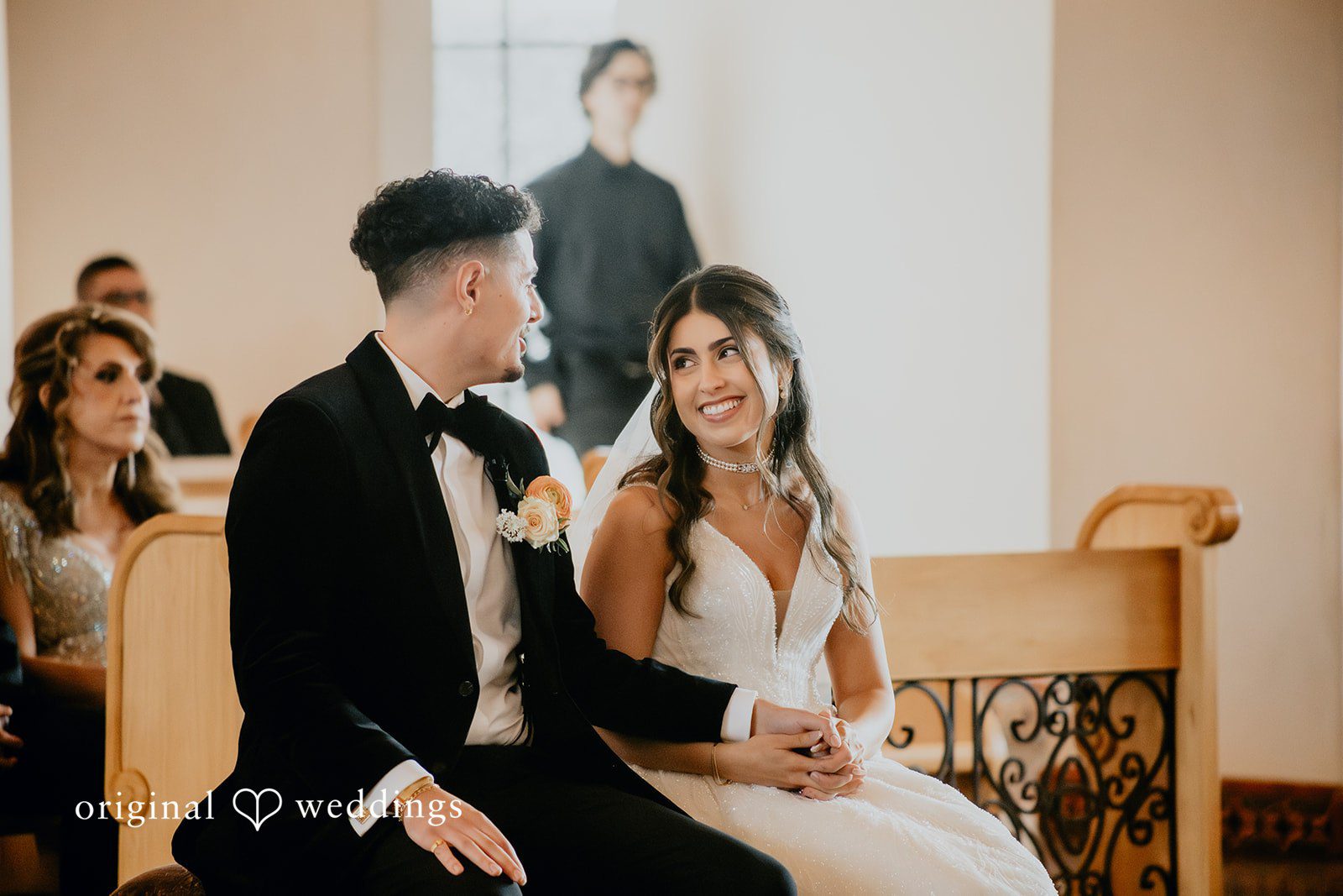 Jakob + Flowreen A portrait of the couple seated in church