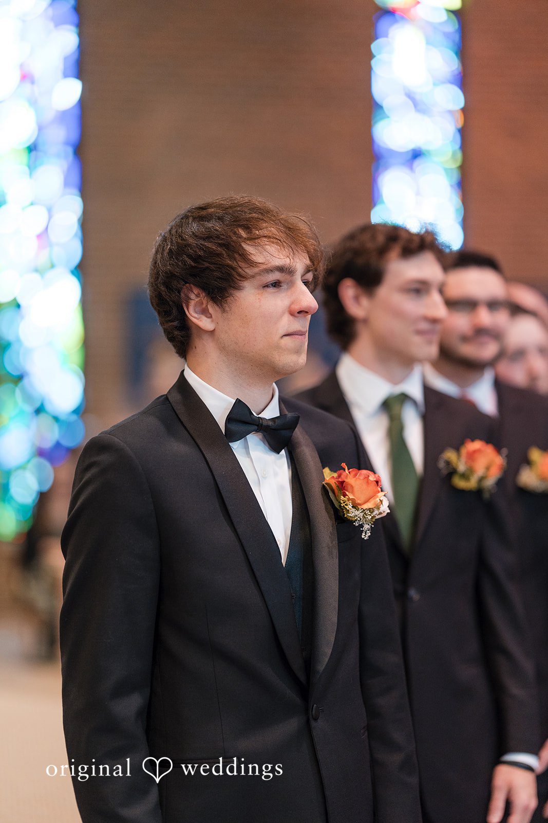 An emotional portrait of the groom in anticipation of the bride at St Joseph Church