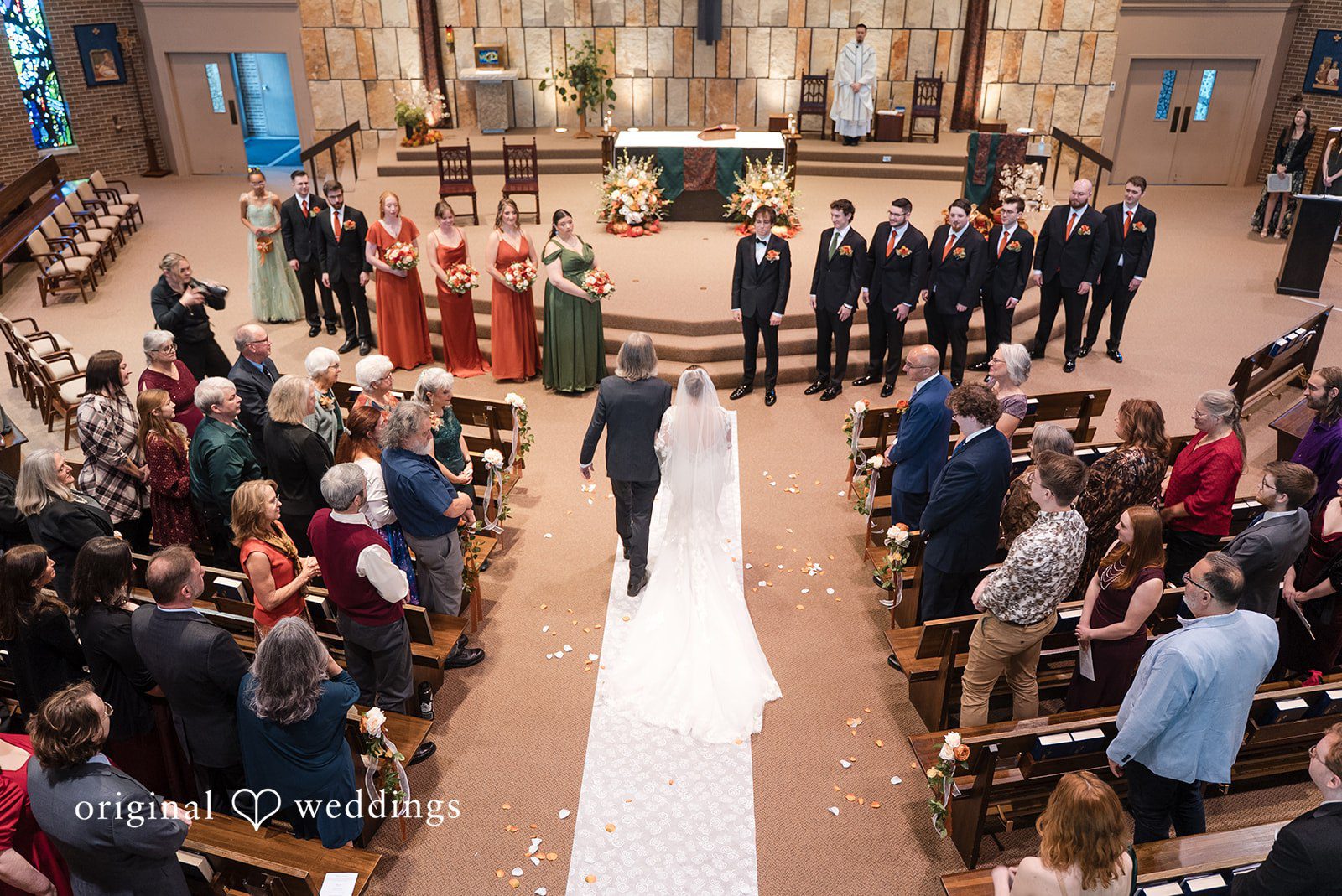 A portrait of the bride and her father walking down to St Joseph Church' altar