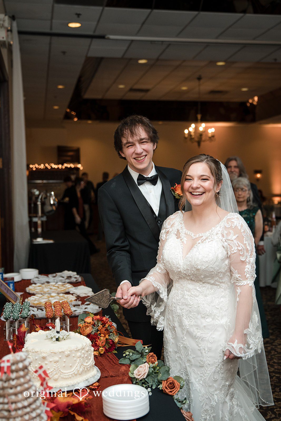 A portrait of the couple about to cut the cake