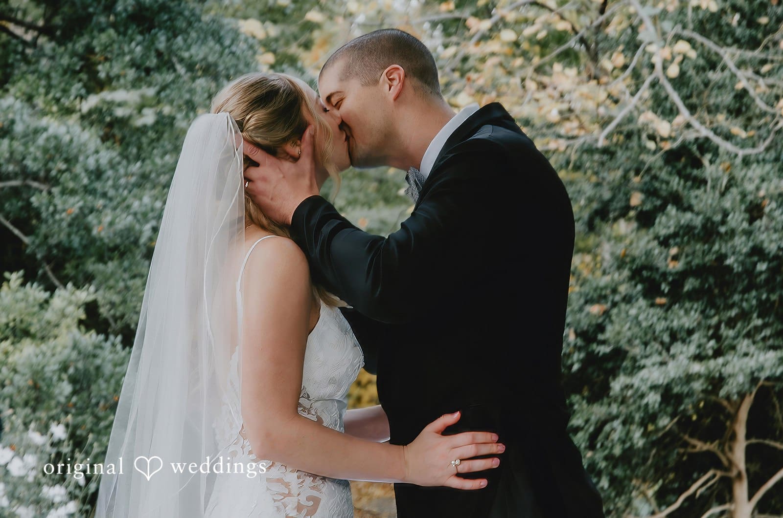 The bride and groom seal their union with a romantic kiss at St. Louis Botanical Gardens