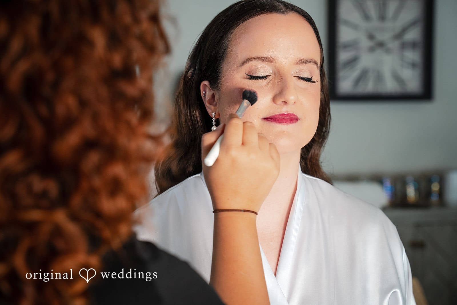 Bride getting ready with makeup during wedding morning preparations