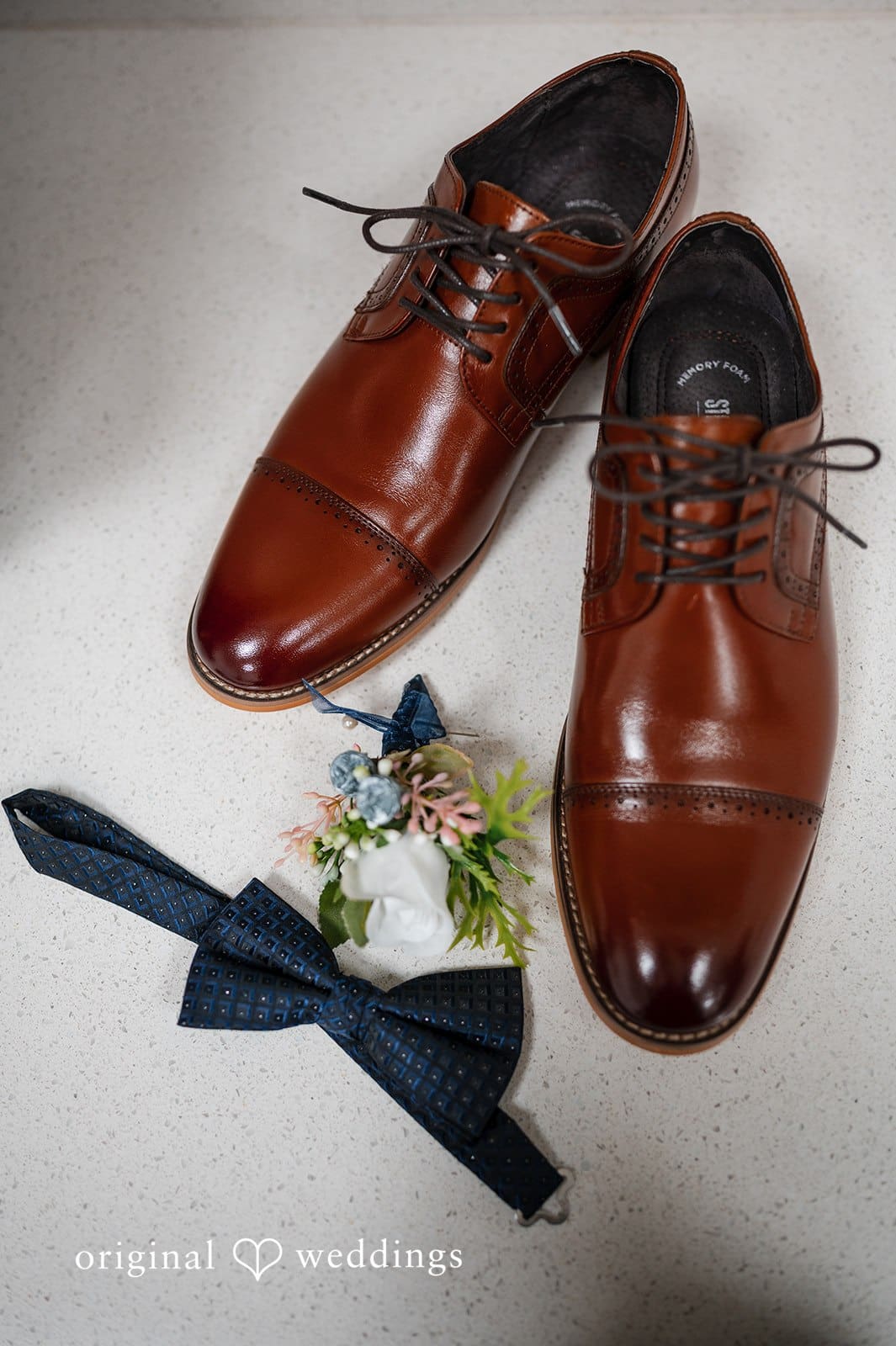 Groom’s brown wedding shoes with boutonniere detail