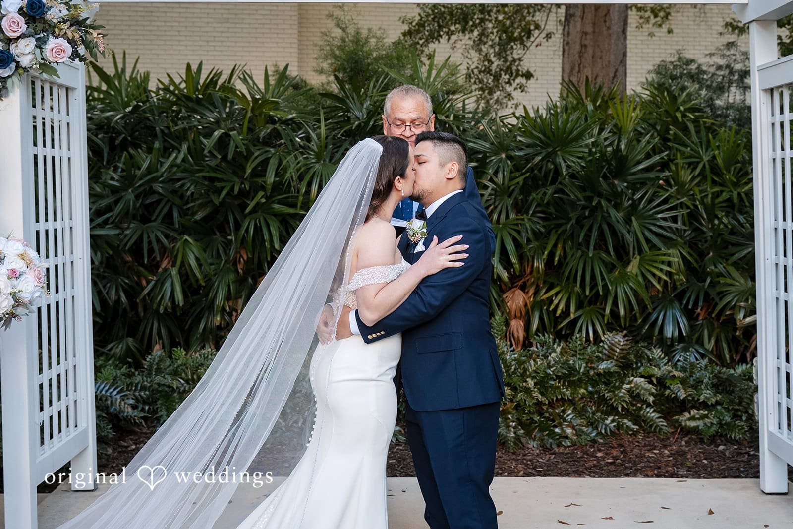Newly married couple celebrating and embracing after their garden ceremony at Tampa Garden Club