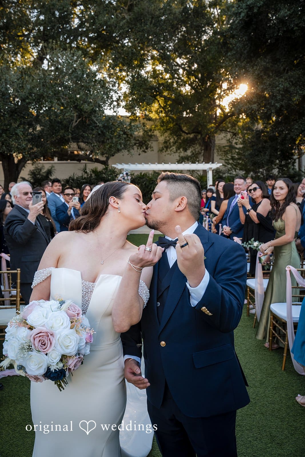 Romantic portrait of the newly married couple in the garden after the ceremony