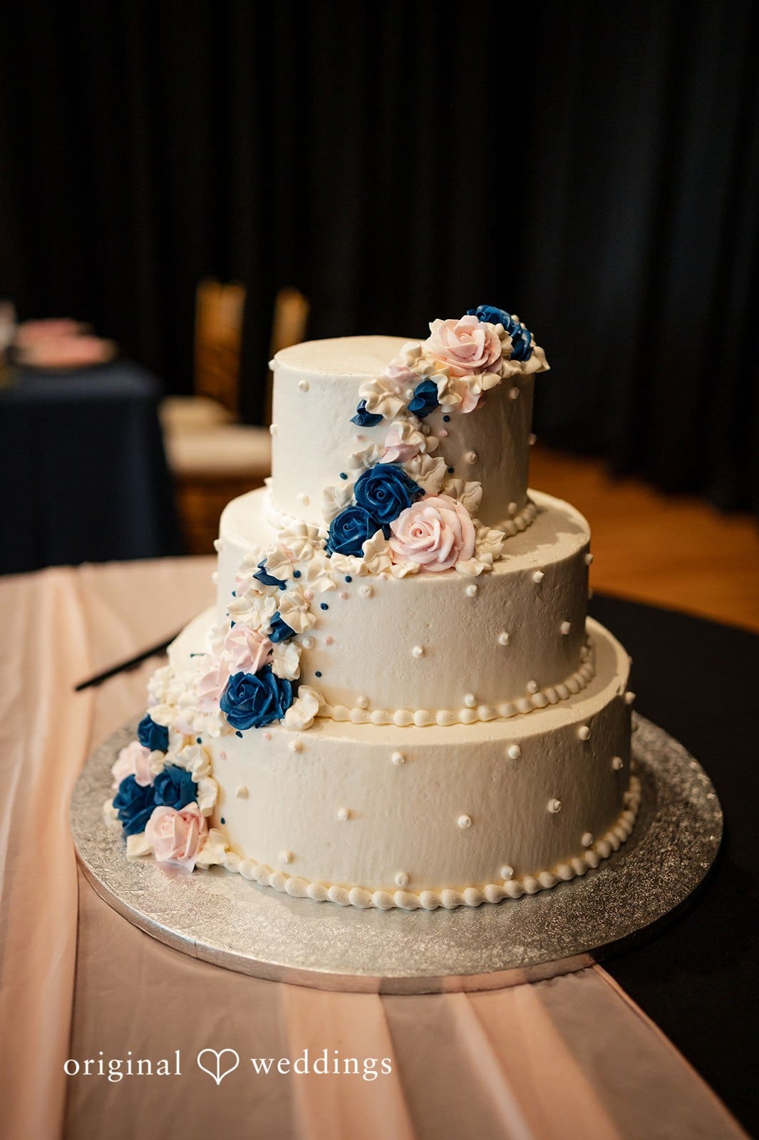 White wedding cake with blue floral details at Tampa Garden Club reception