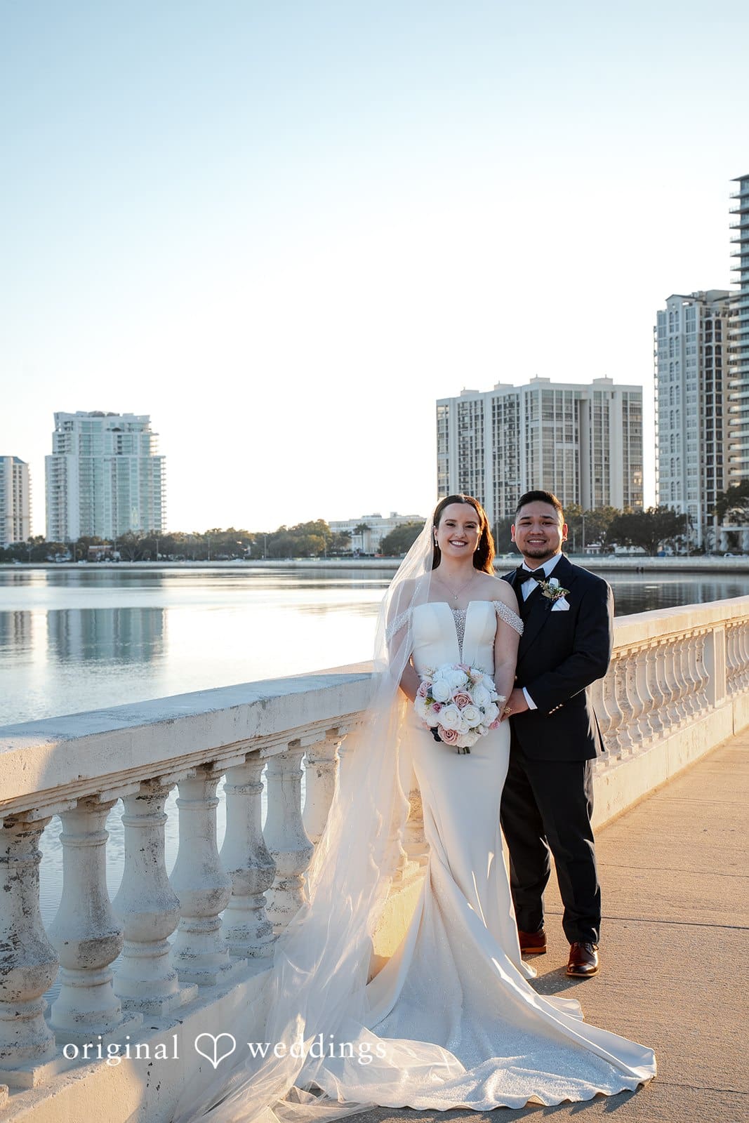 Bride and groom posing together along the Bayshore Boulevard waterfront