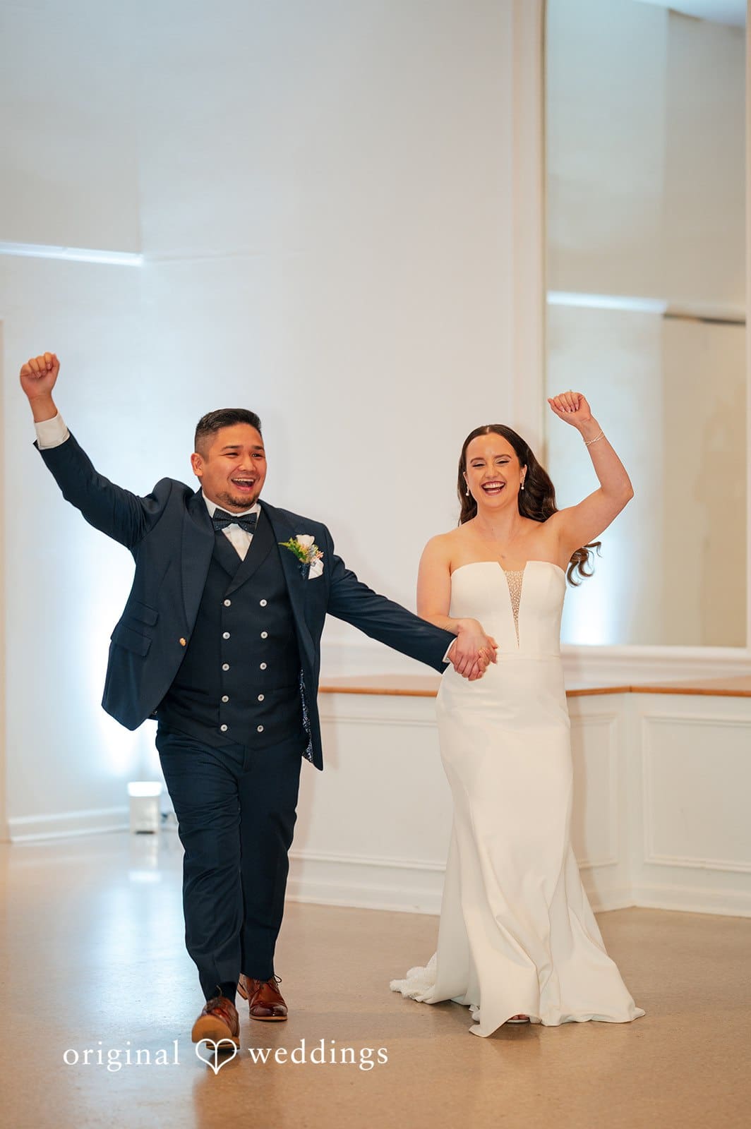 Bride and groom celebrating their entrance into the reception
