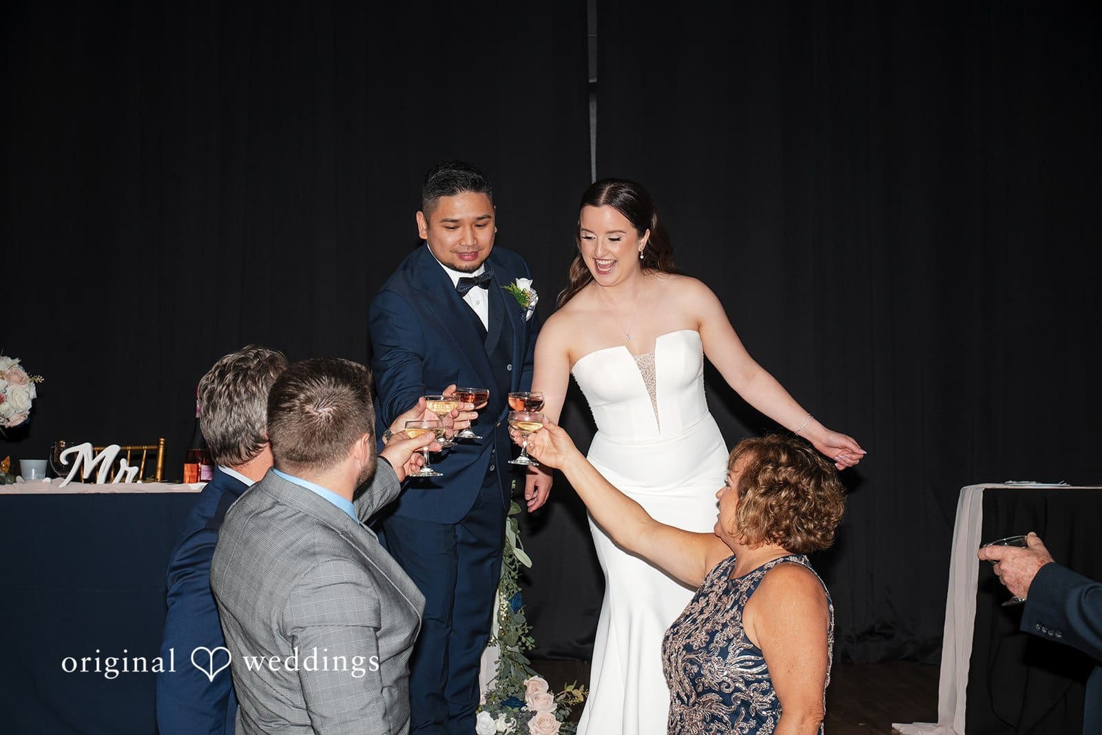 Wedding guests cheering and celebrating on the dance floor