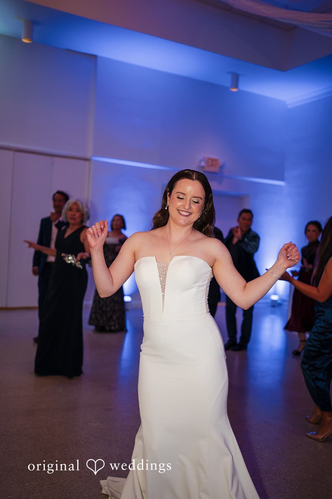 Bride dancing with friends on the lively reception dance floor