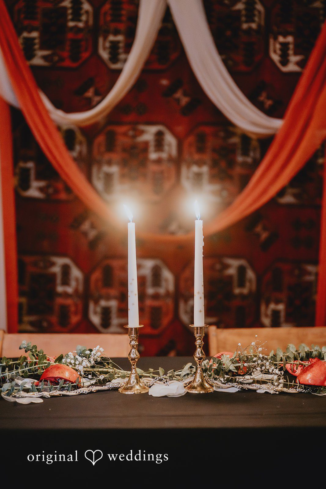 Decorated tables with florals and moody candles at The Cooperage wedding reception
