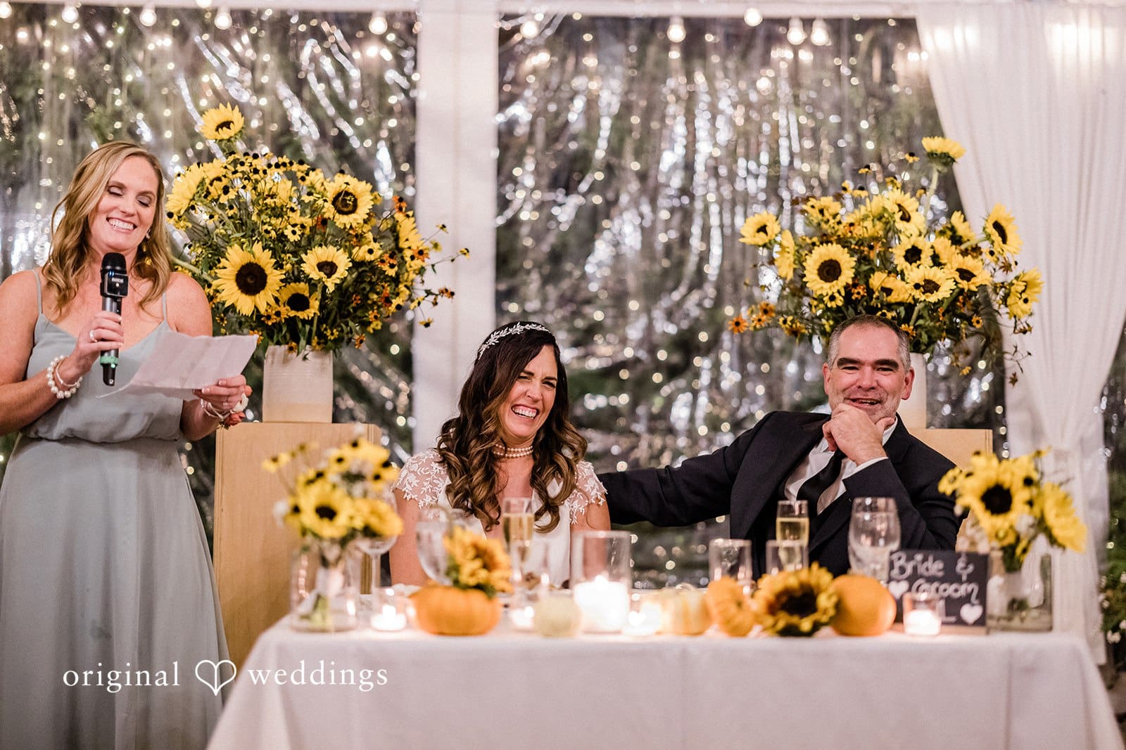 Bride and groom smiling during wedding speech at Manor house reception