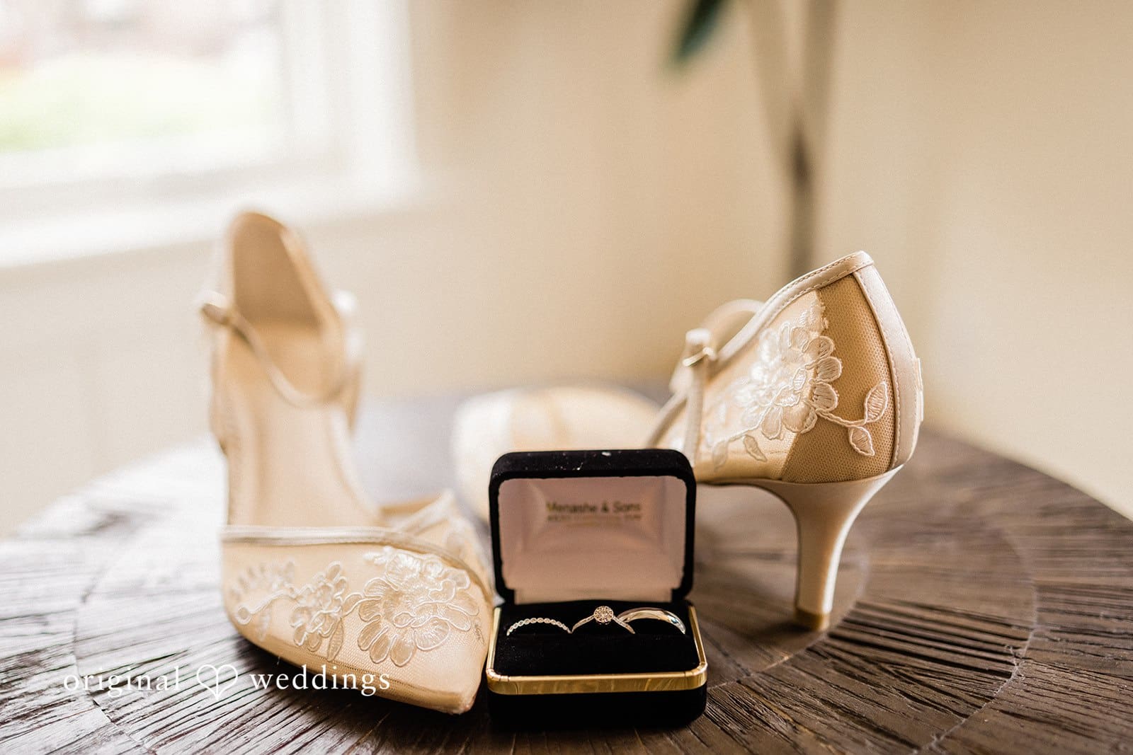 Beautiful picture of bride's shoes and wedding rings