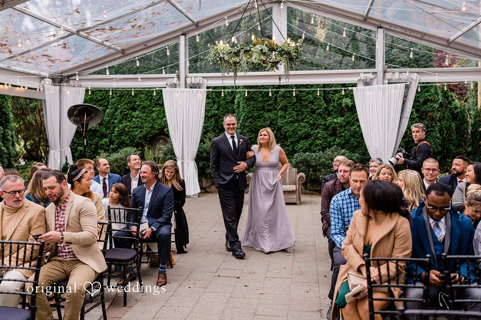 Groom walking down the aisle, smiling and enjoying a joyful moment with a companion