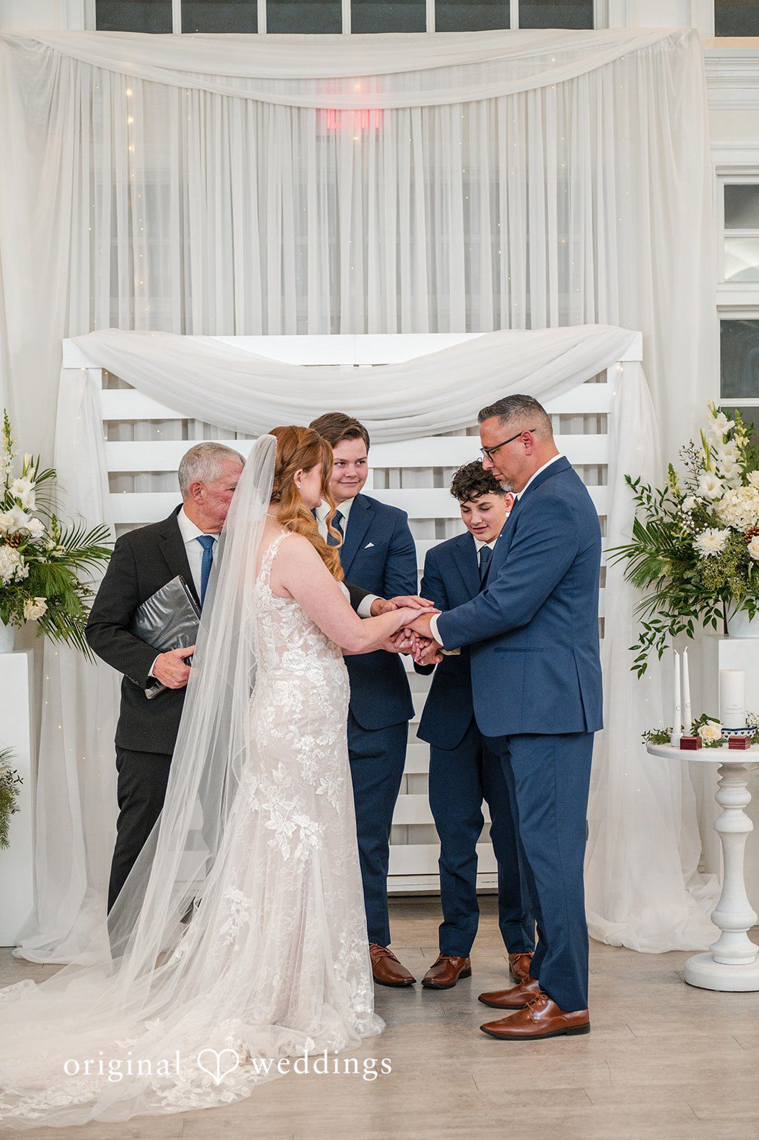 Caitlyn + Greg Couple exchanging vows at The Osprey’s at Belmont Bay captured by DC wedding photographer from original weddings