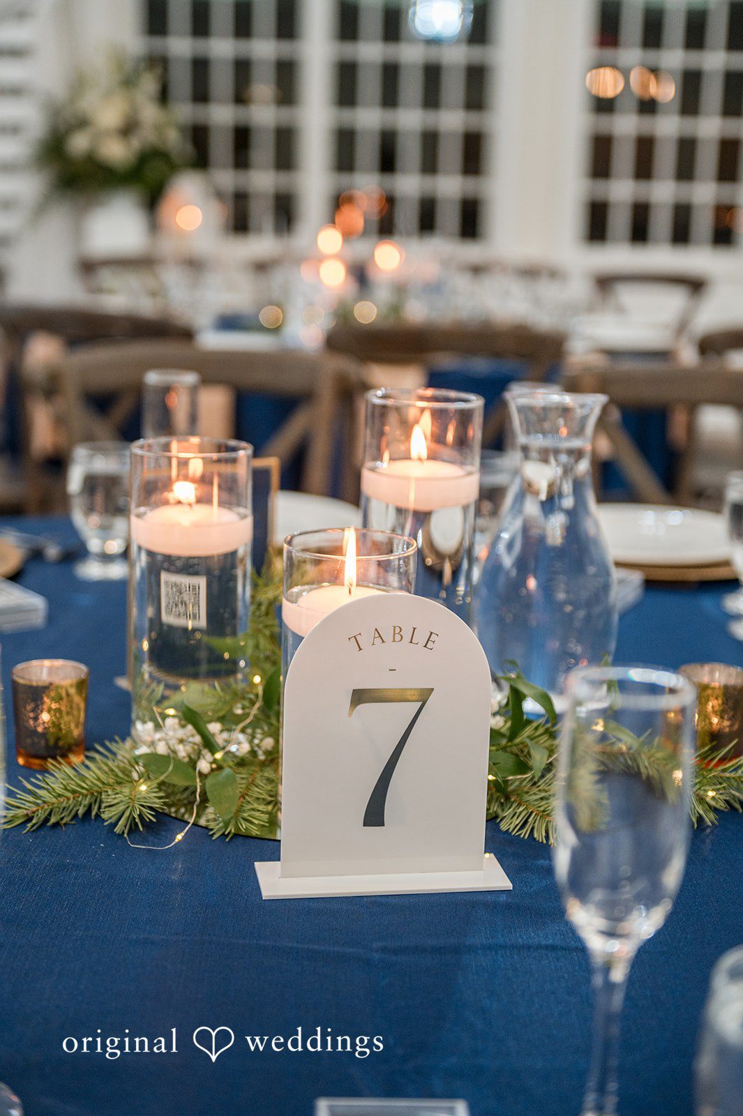 Caitlyn + Greg Wedding table centerpiece with candles and table number display at The Osprey’s at Belmont Bay