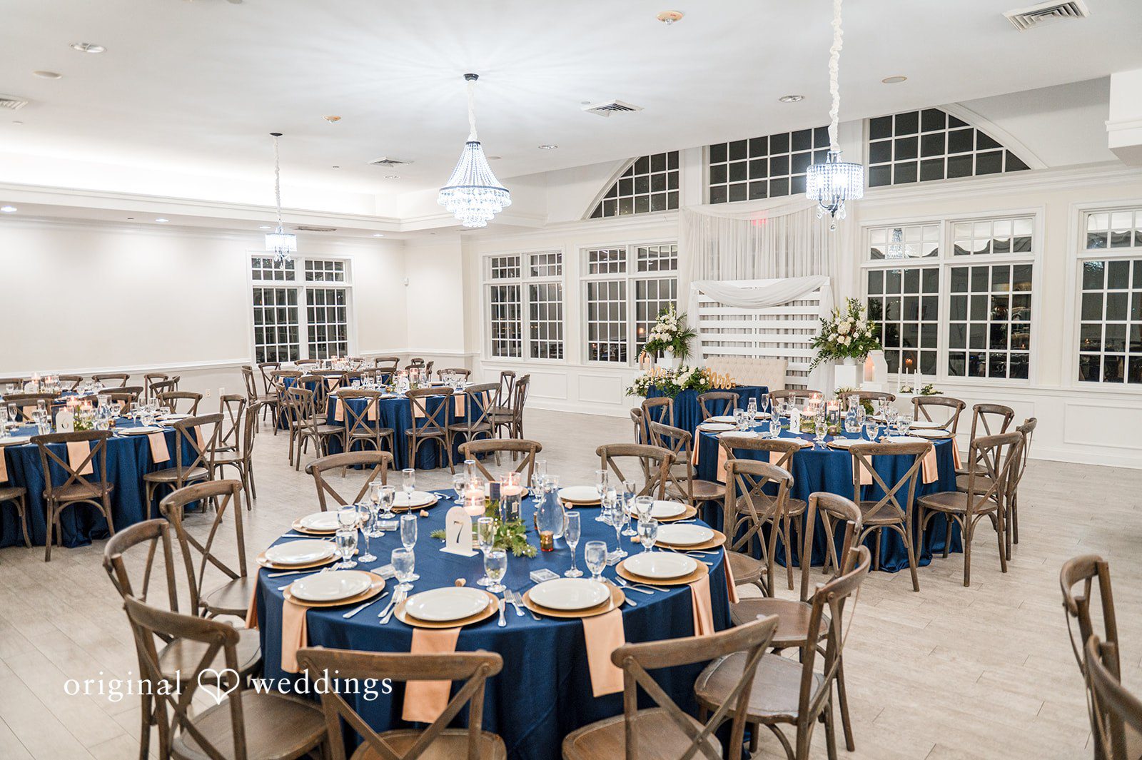 December 21, 2025 – Caitlyn & Greg – (ID-3654) Elegant reception setup with blue and gold table decor in a bright hall