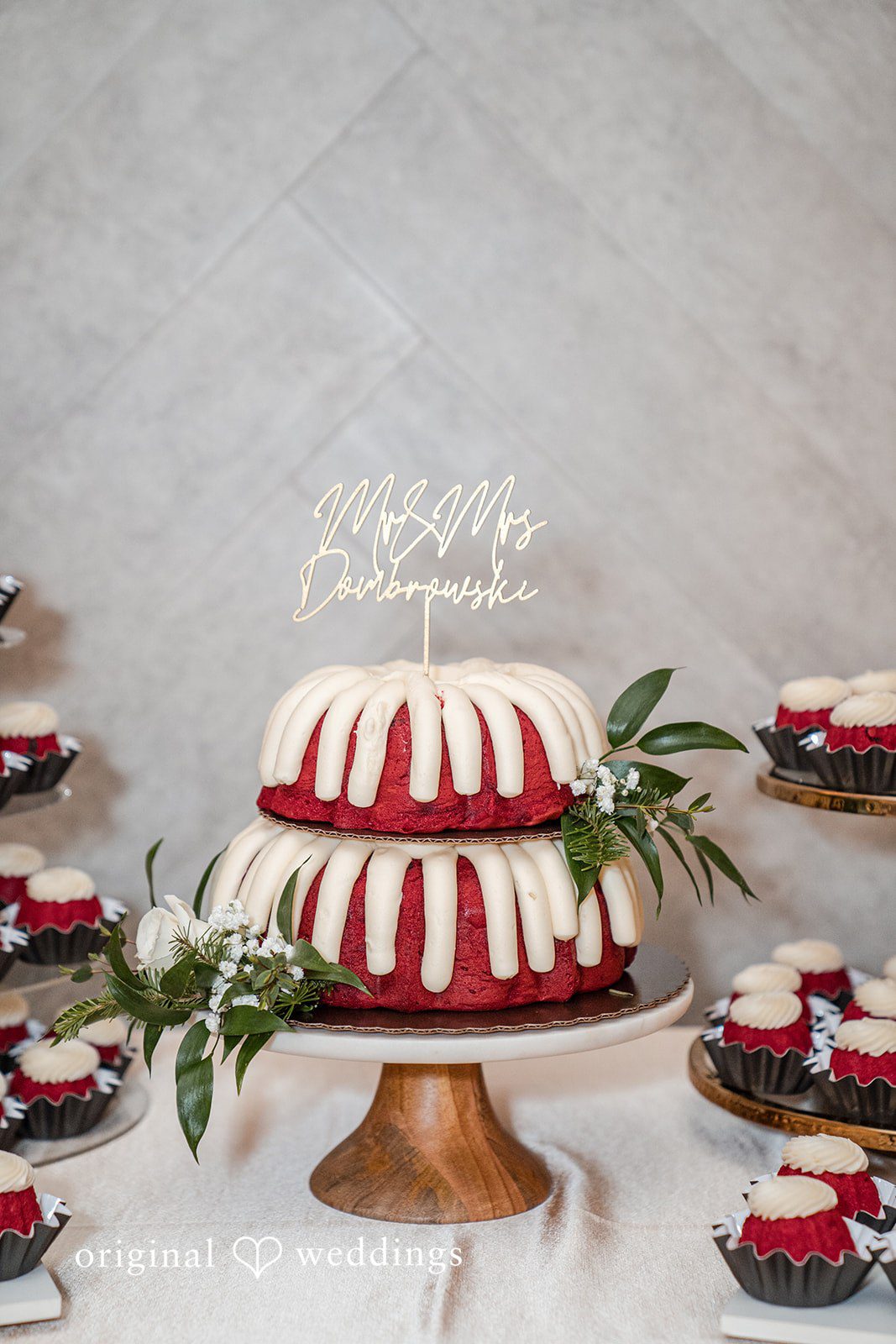 Caitlyn + Greg Tiered wedding cake with red and white design on display.